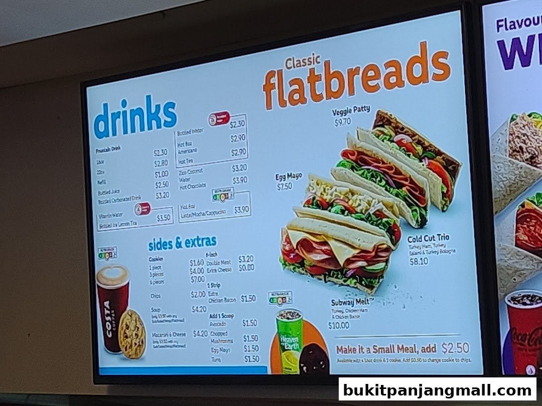 A menu board displaying drinks, classic flatbreads, and sides with prices.