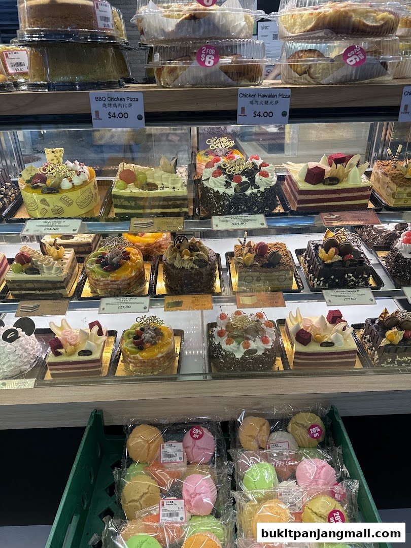 A display of various cakes and pastries at Swee Heng Bakery, with some items on promotion.