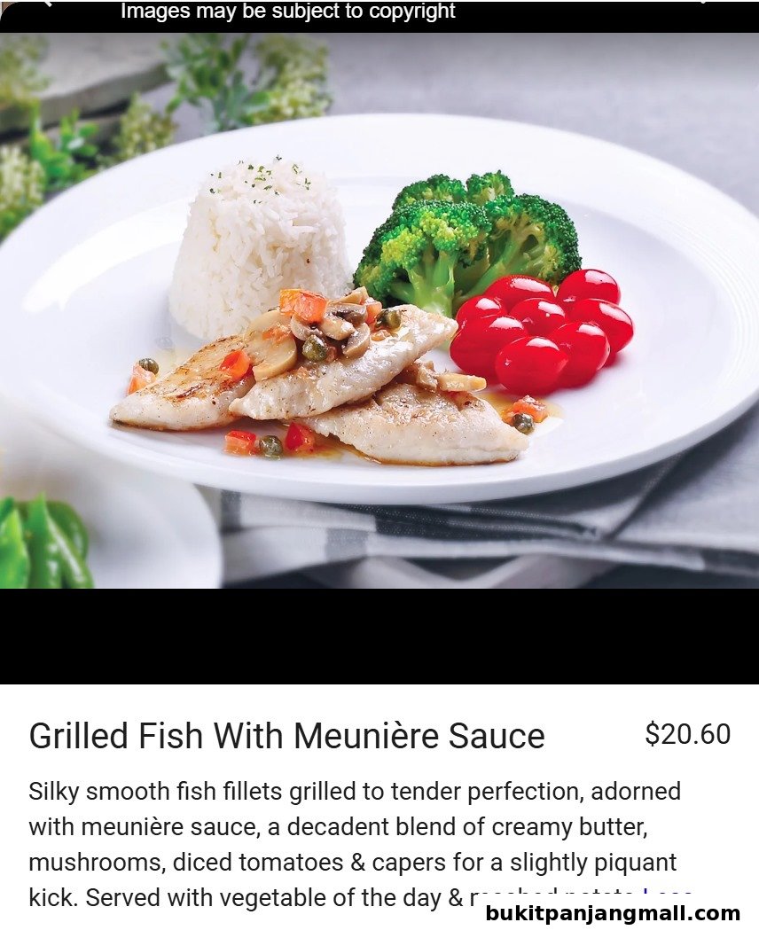 A plate of grilled fish with meunière sauce, rice, broccoli, and cherry tomatoes.
