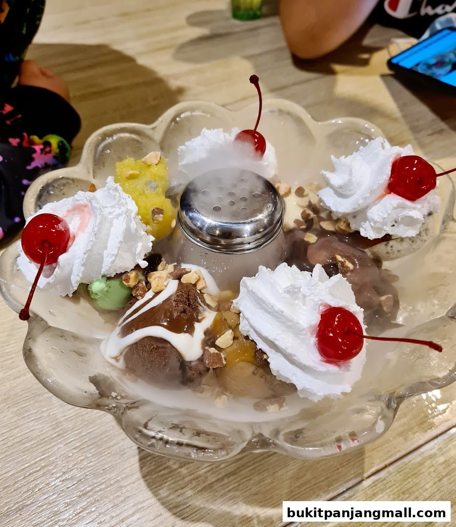 A visually appealing ice cream sundae with whipped cream, cherries, nuts, and dry ice.
