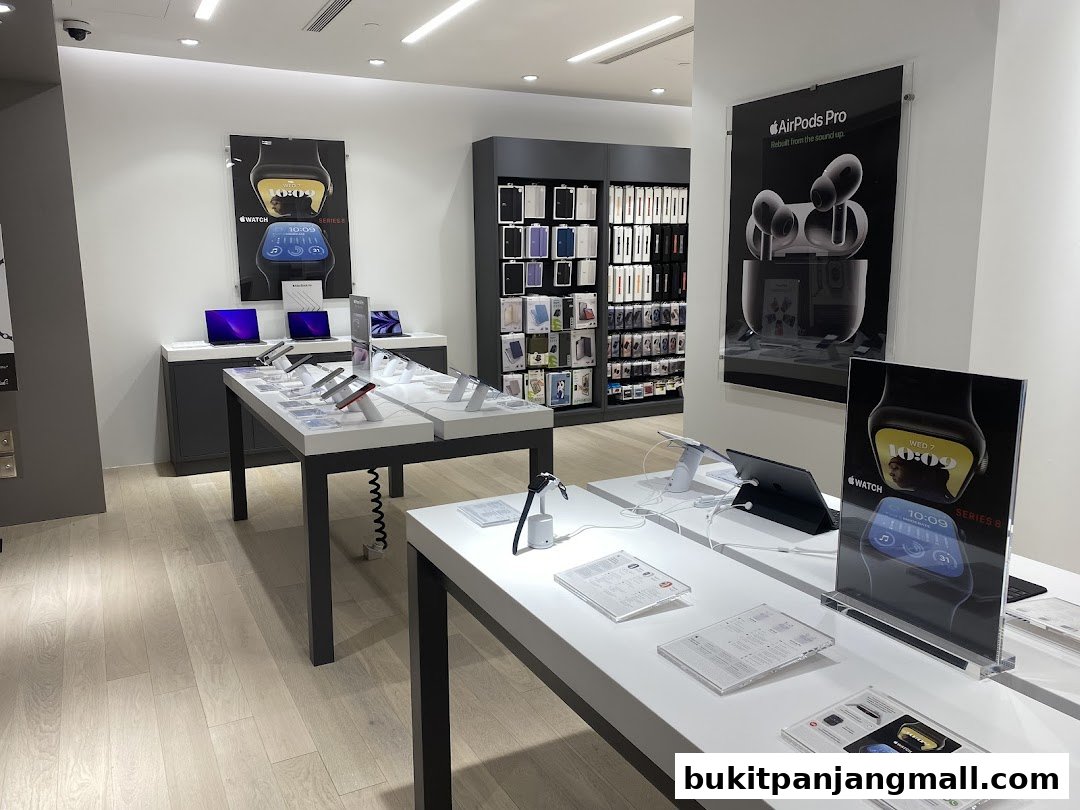 Interior of a modern electronics store showcasing Apple products like watches and AirPods.