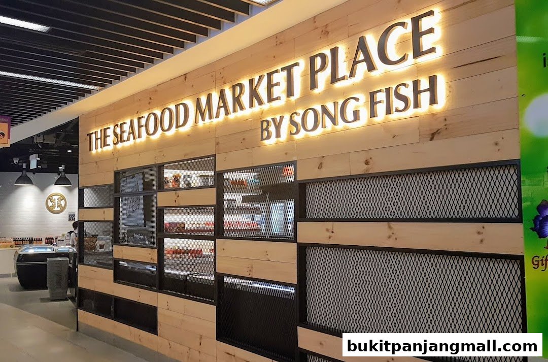 The illuminated sign of 'The Seafood Market Place By Song Fish' on a wooden wall.