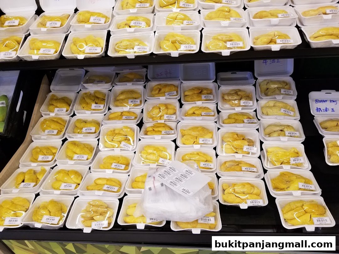 Rows of pre-packaged durian fruit in white styrofoam containers on shelves.