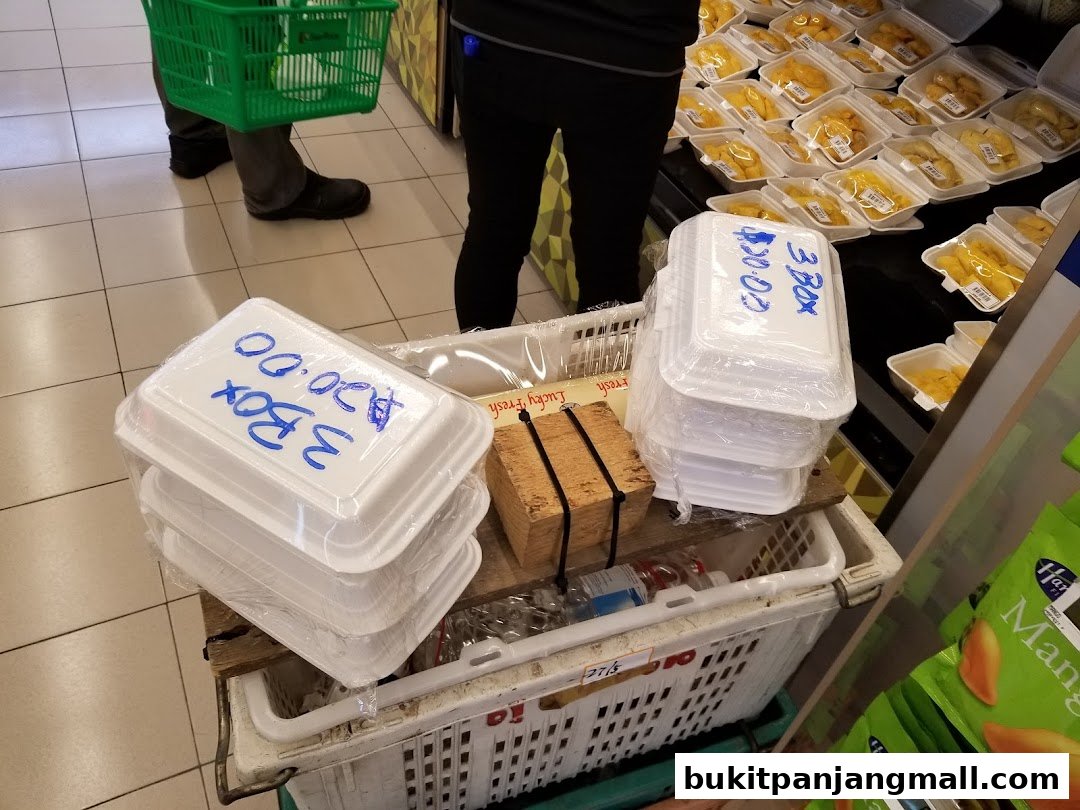 A display of pre-packaged food items in white containers with handwritten price labels.