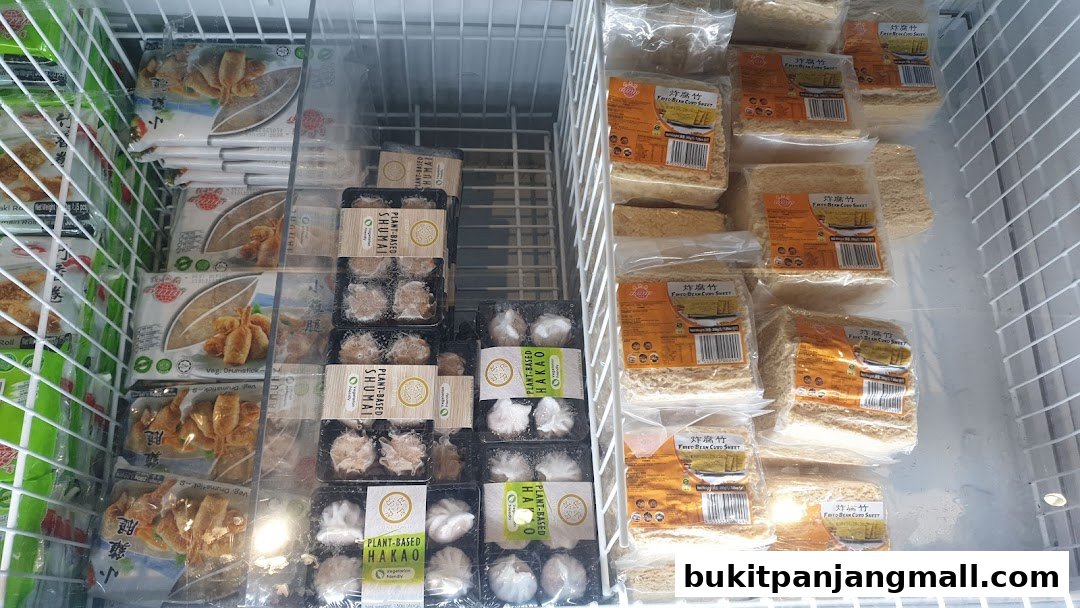 Frozen food products including plant-based dim sum and fried bean curd sheets in a display freezer.