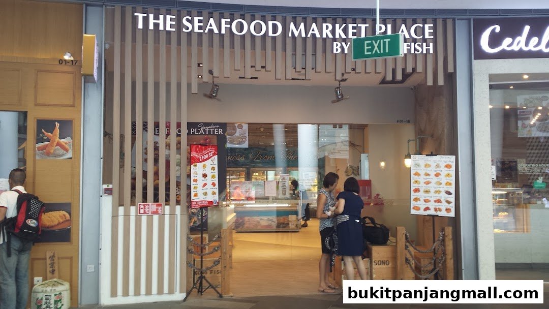 The entrance of The Seafood Market Place By Song Fish, featuring its signage and a display of seafood dishes.