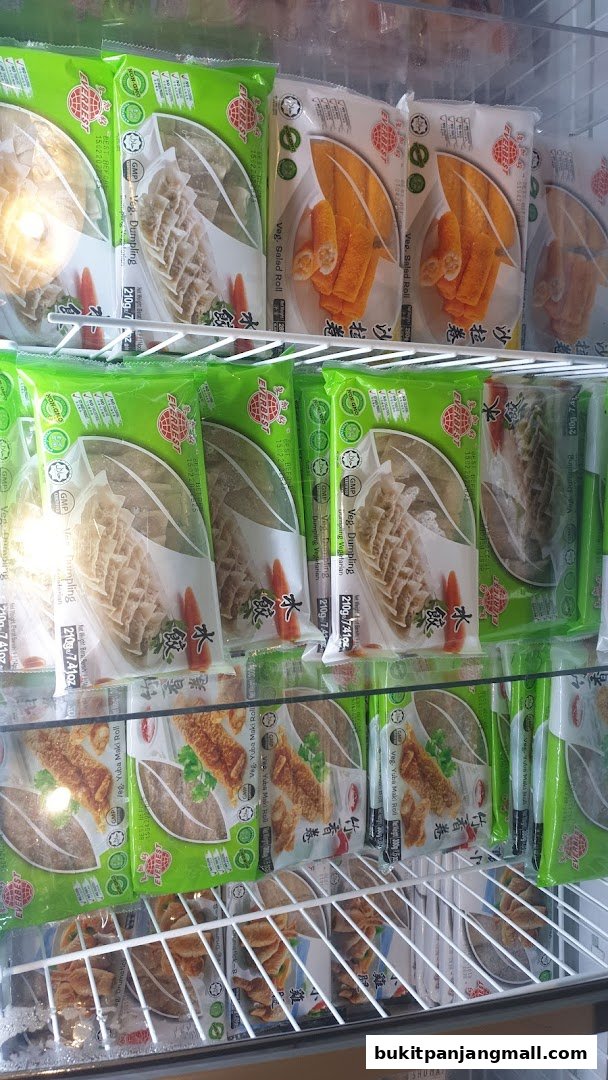 Frozen food products, including dumplings and spring rolls, displayed in a refrigerated case.