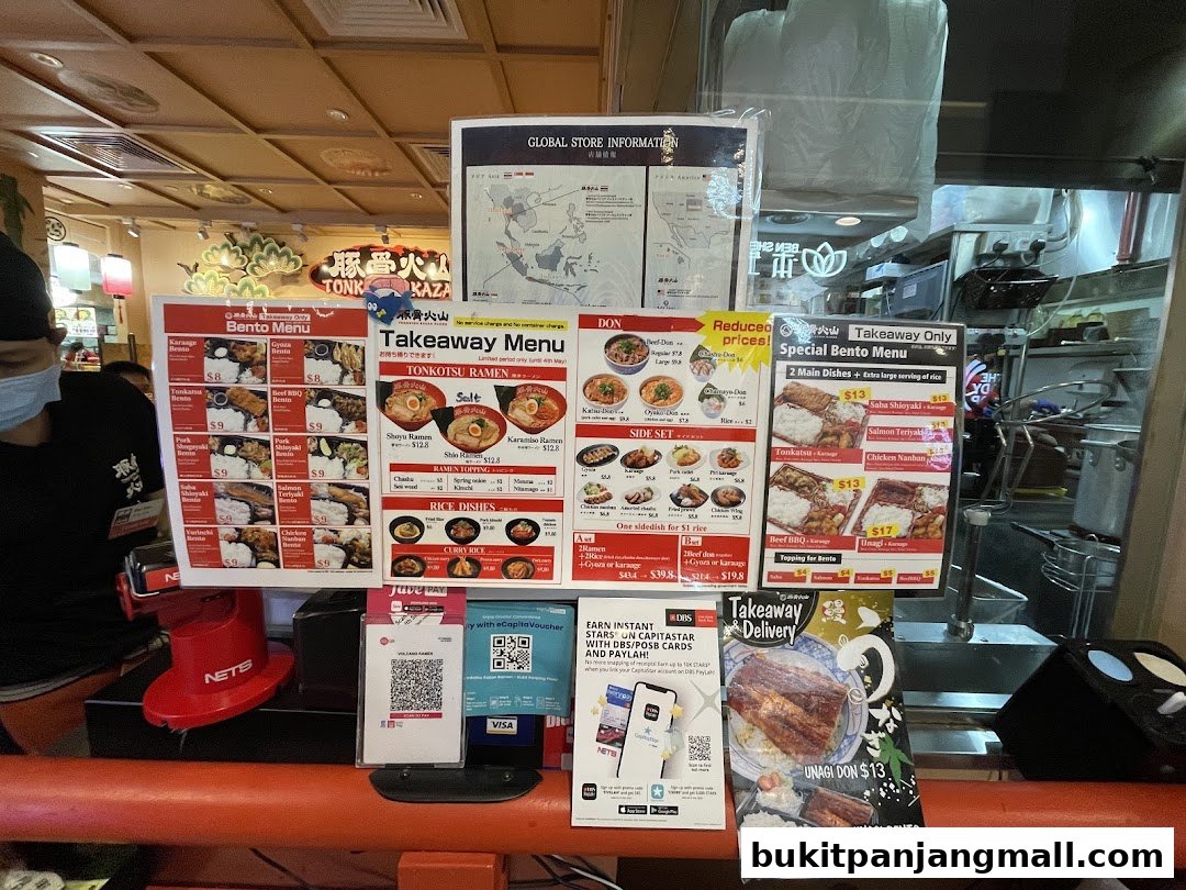 A display of takeaway menus and promotional flyers for Tonkotsu Kazan restaurant.