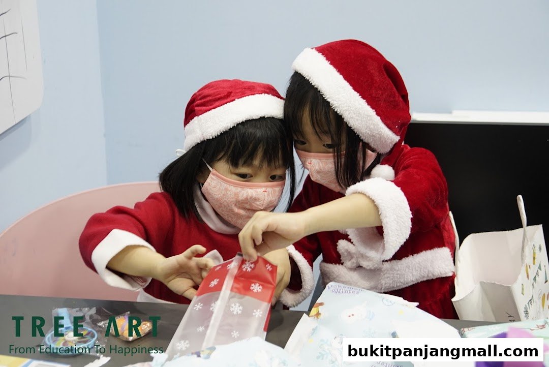Two children in Santa outfits and masks are opening gift bags.