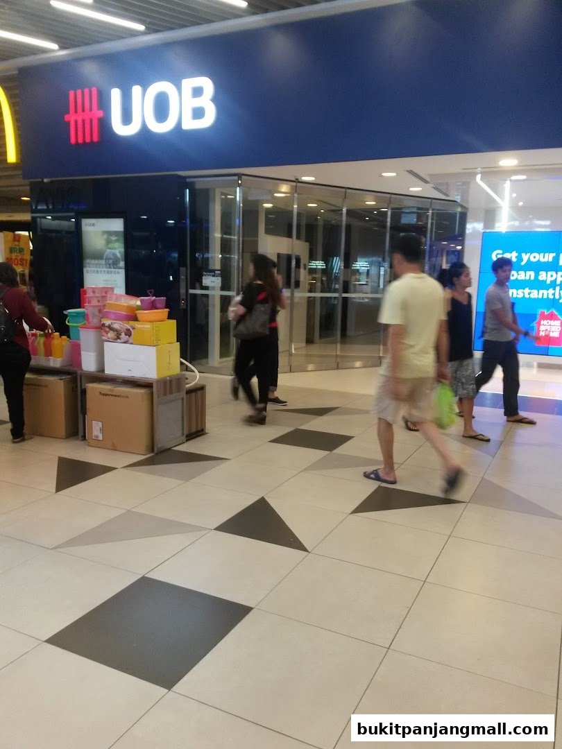 The UOB Bank branch entrance with people walking by and promotional displays.