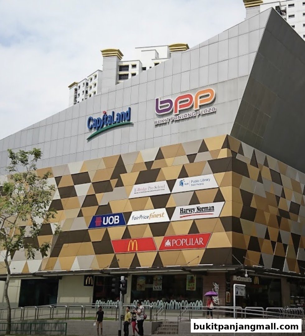 Exterior view of Bukit Panjang Plaza featuring various retail store signs and the CapitaLand logo.
