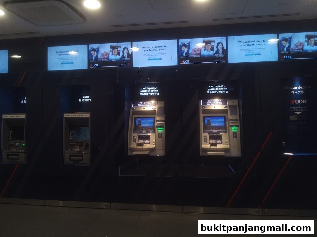 UOB bank branch with multiple ATMs and digital displays showing business solutions.
