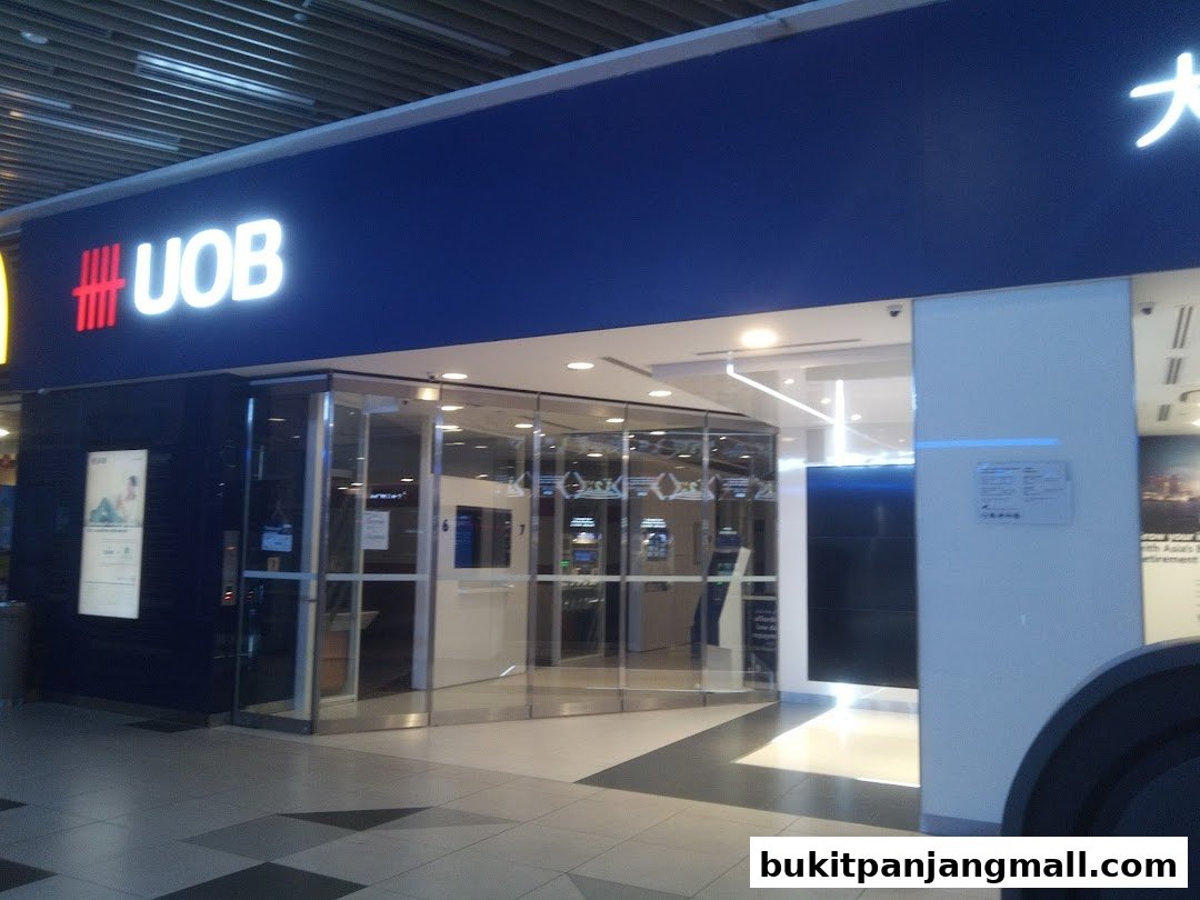 The modern entrance of a UOB bank branch with glass doors and clear signage.