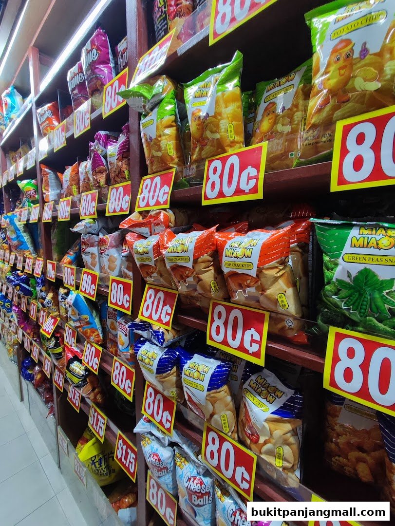 Shelves stocked with various snack bags, many priced at 80 cents.