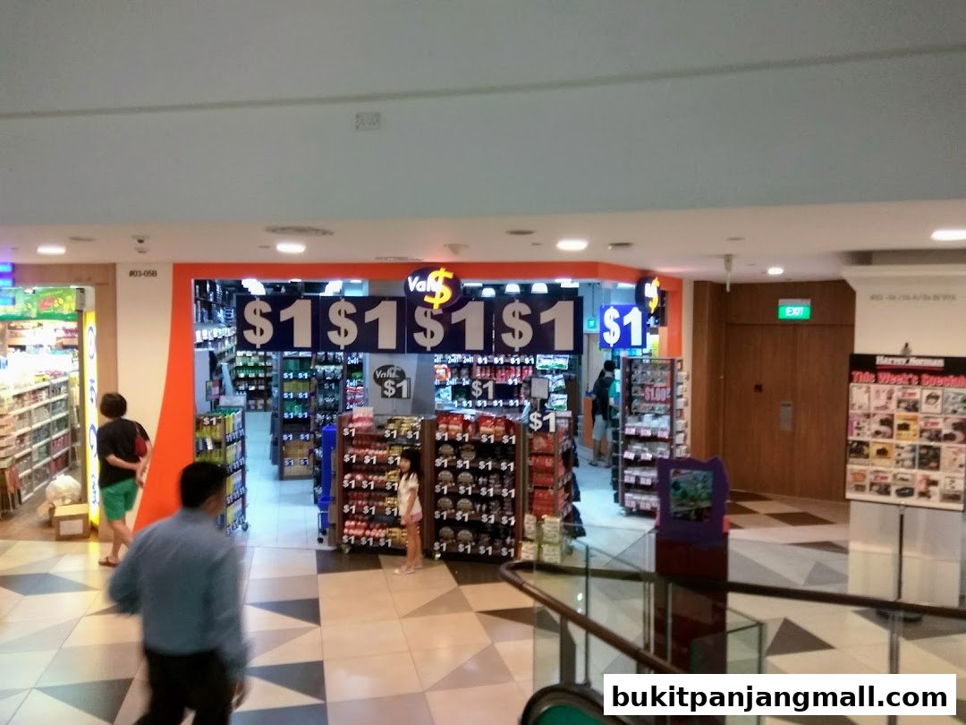The entrance to a Valu store with prominent '$1' signage and shelves stocked with various products.