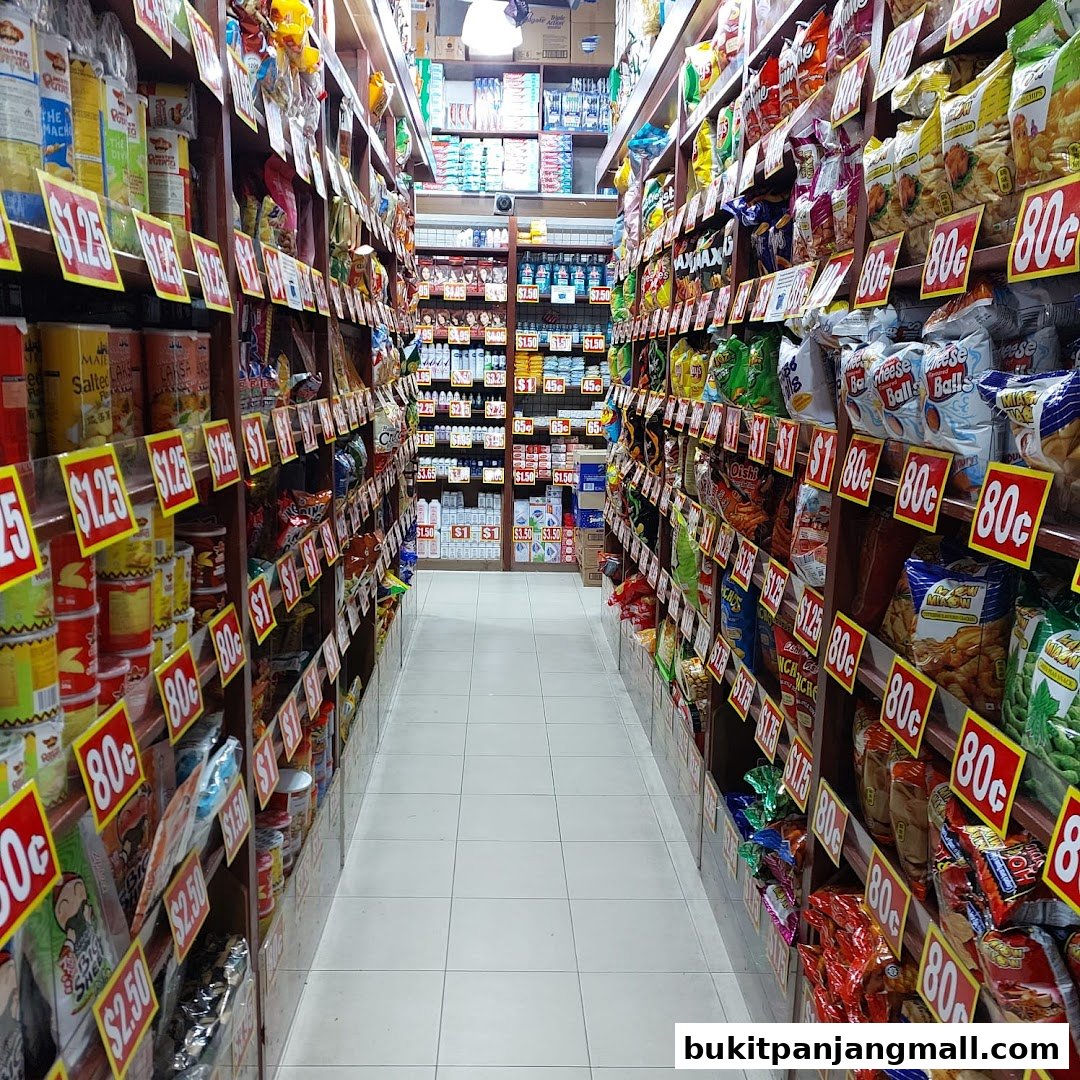 Aisle of a grocery store with shelves stocked with snacks and canned goods, many with price tags.