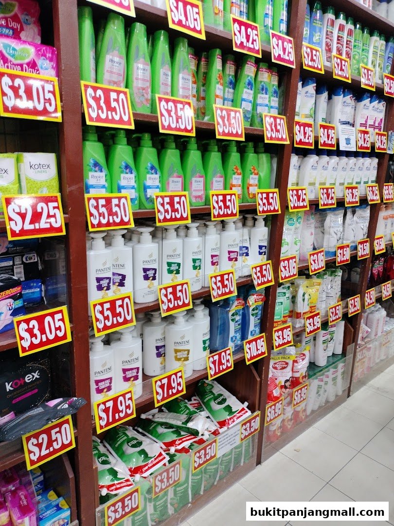 Shelves stocked with various personal care products like shampoo, conditioner, and sanitary pads, with price tags displayed.