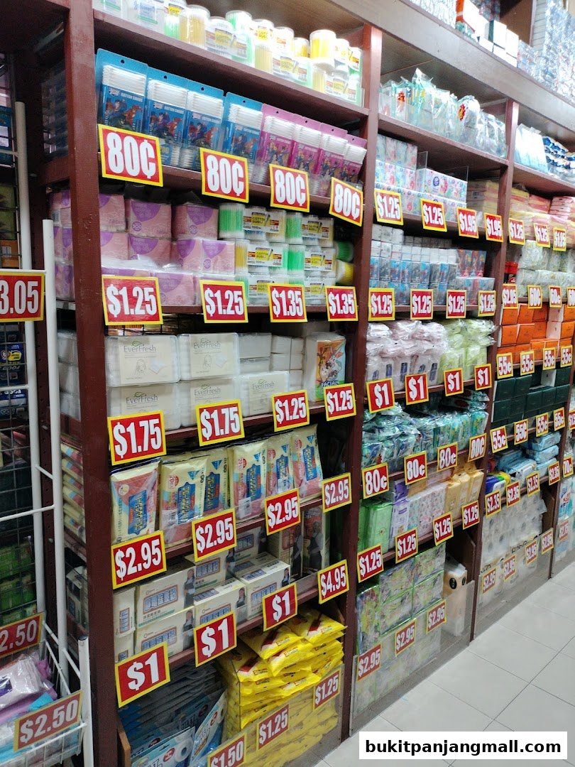 Shelves stocked with various household items and personal care products with price tags.