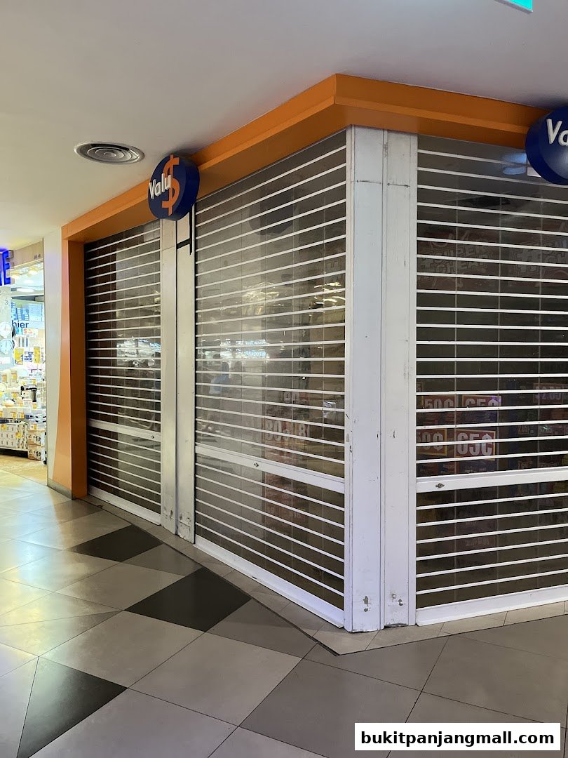 The Valu shop with its shutters down, showing a glimpse of products inside.