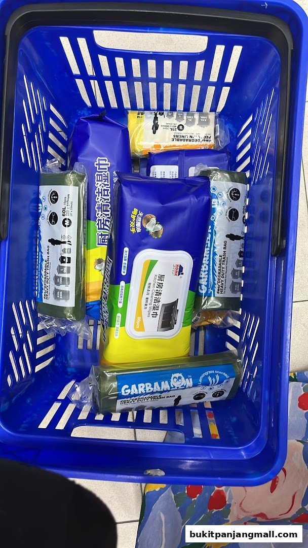 A blue shopping basket filled with various cleaning supplies and trash bags.