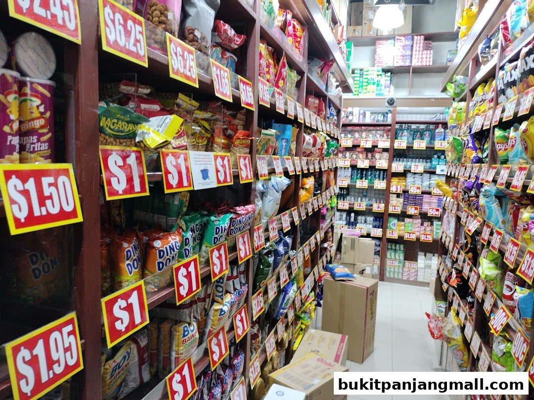 Aisle of a grocery store with shelves stocked with snacks and various products, many with price tags.