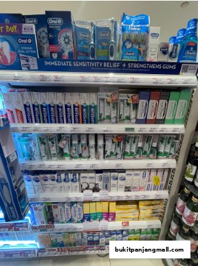 Shelves stocked with various oral hygiene products, including toothbrushes and toothpaste.