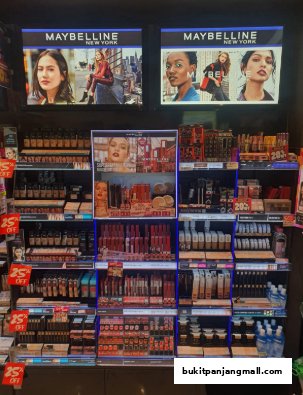 A display of Maybelline New York makeup products, featuring lipsticks, foundations, and mascaras.