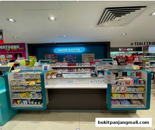 Interior view of a Watsons pharmacy counter with various health and beauty products displayed.