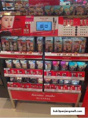 A display of Kiss Me Heroine Make mascara and eyeliner products in a retail store.