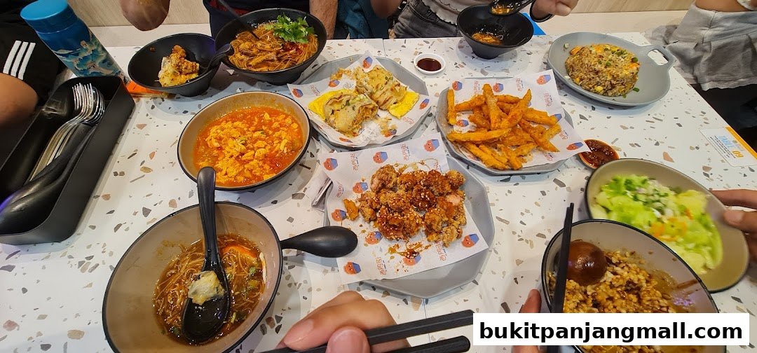 A table filled with various Taiwanese dishes, including fried chicken, noodles, and fried rice.
