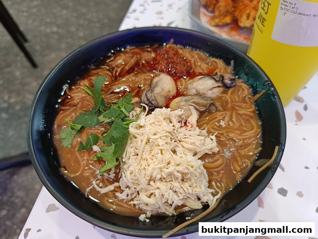 A close-up of a bowl of Taiwanese oyster mee sua with shredded chicken and cilantro.
