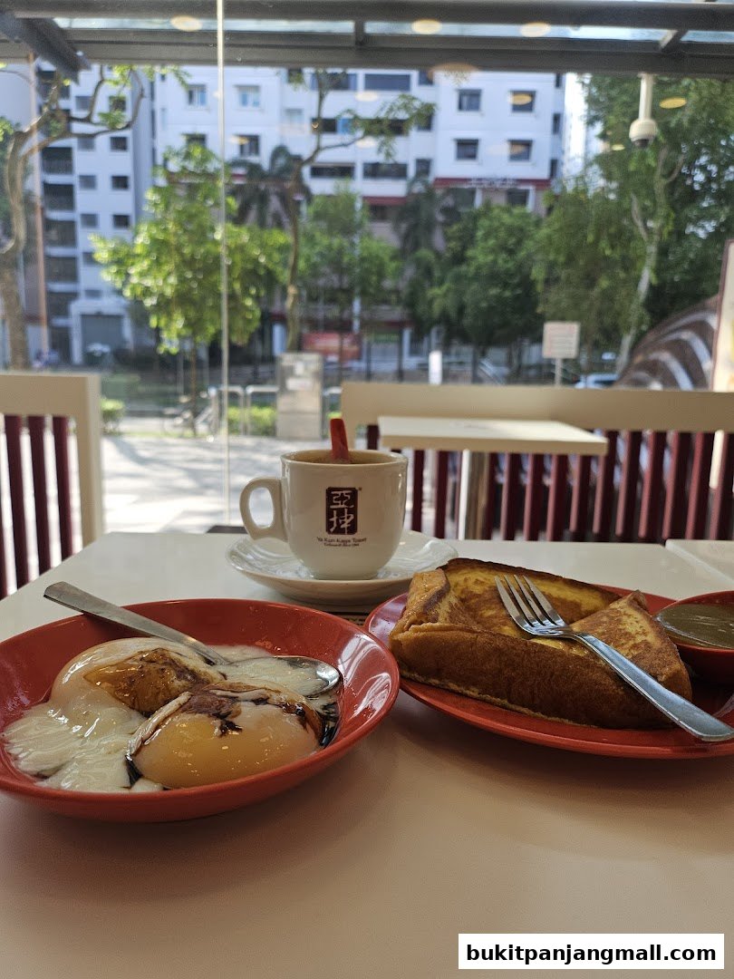 A table setting at Ya Kun Kaya Toast with soft-boiled eggs, kaya toast, and coffee.