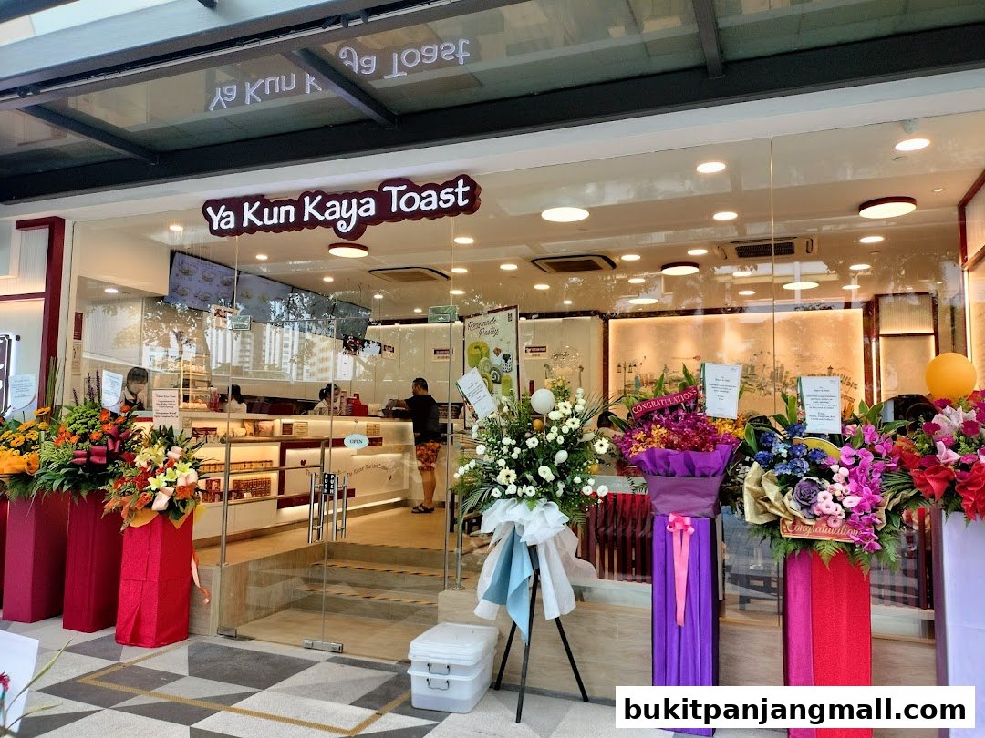 The entrance of Ya Kun Kaya Toast shop decorated with congratulatory flower stands.