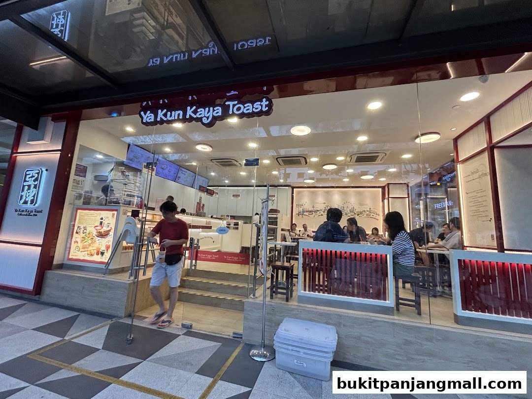 The exterior of Ya Kun Kaya Toast, a popular eatery, with customers inside.