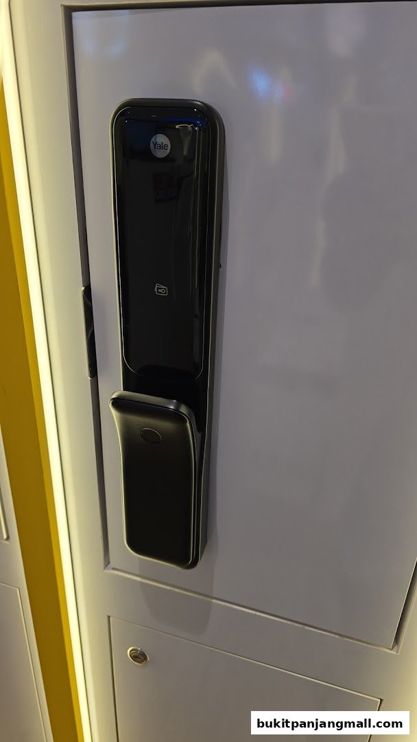 A close-up of a sleek, black Yale smart lock mounted on a white surface.