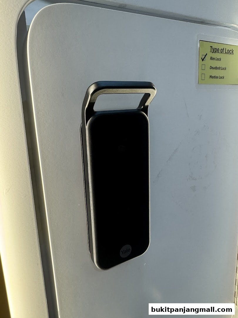 A close-up of a Yale smart lock on a door with a 'Type of Lock' label.