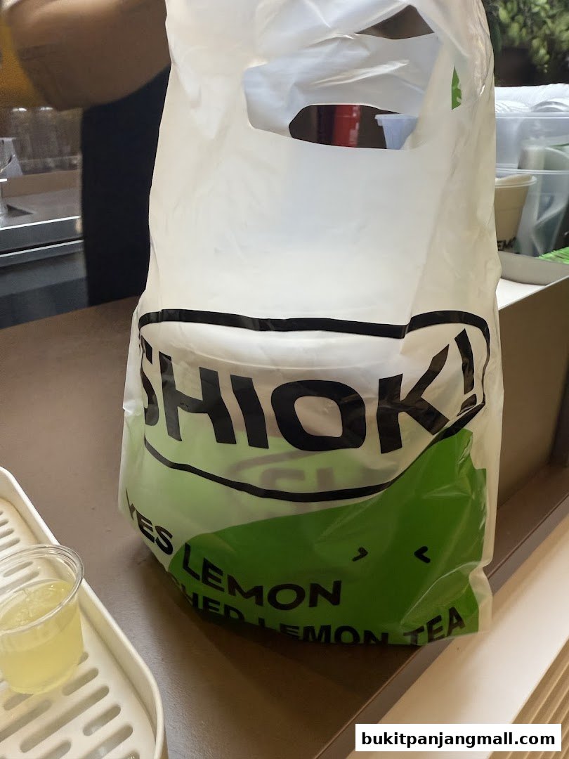A shopping bag from YES LEMON BPP with a drink in a cup on a tray.