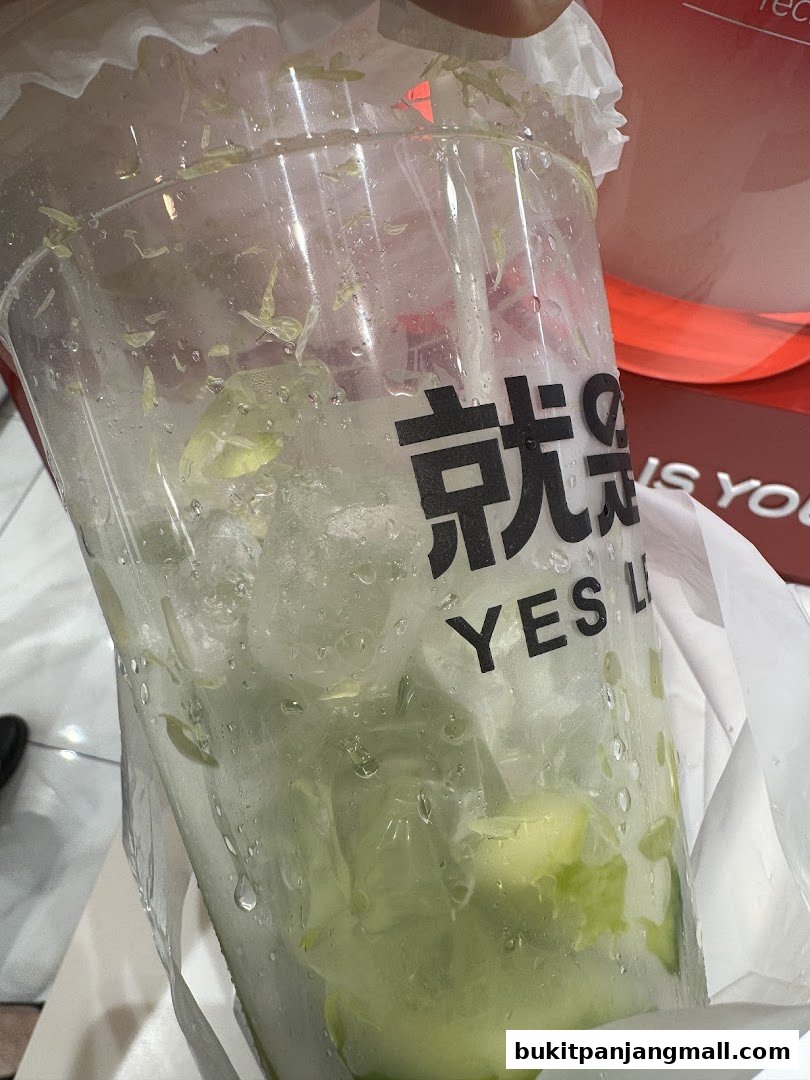 A close-up of a refreshing drink with ice and lemon slices from YES LEMON BPP.