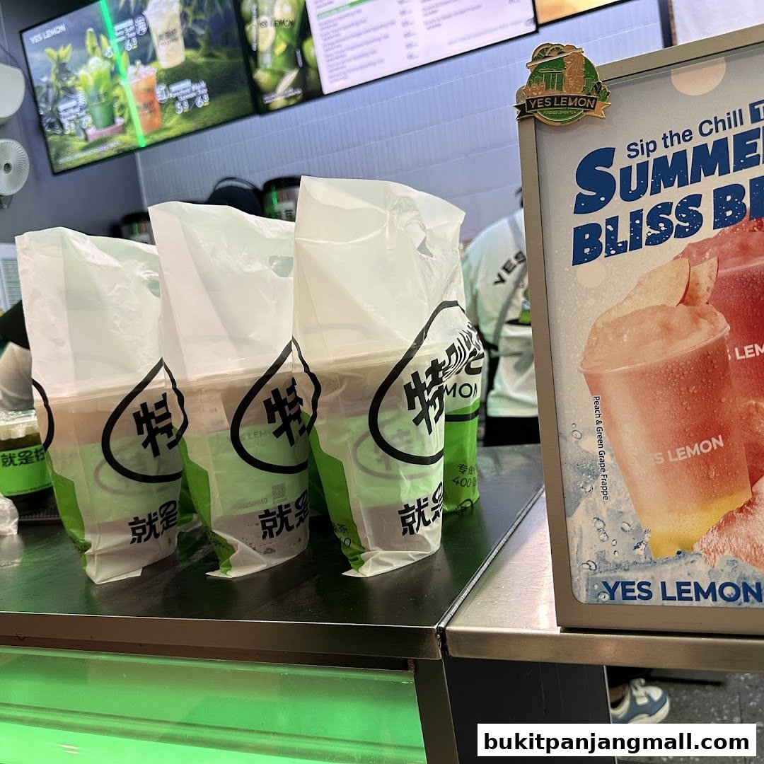 Several takeaway drinks in branded bags are lined up on a counter with a promotional sign.