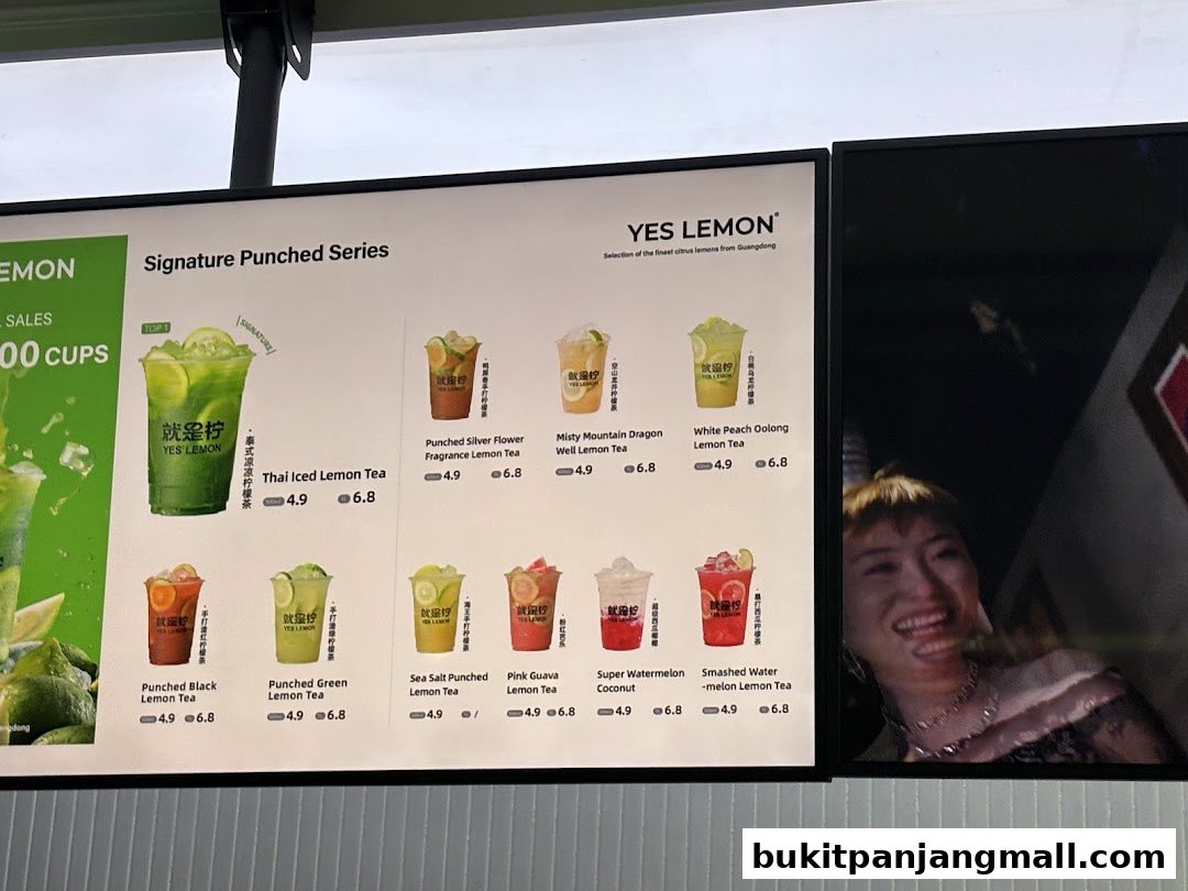 A menu board displays various signature punched lemon tea drinks with prices.