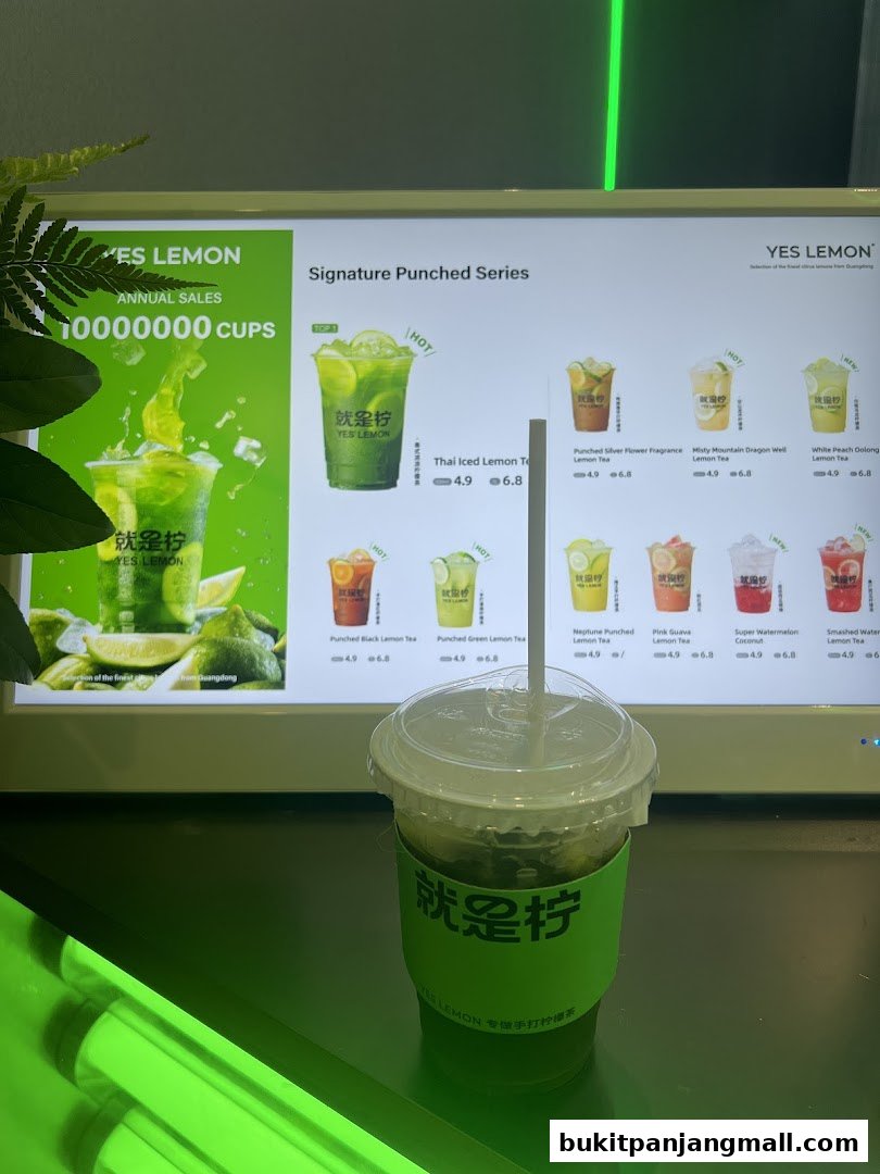 A digital menu board displaying various lemon tea drinks with prices and images.