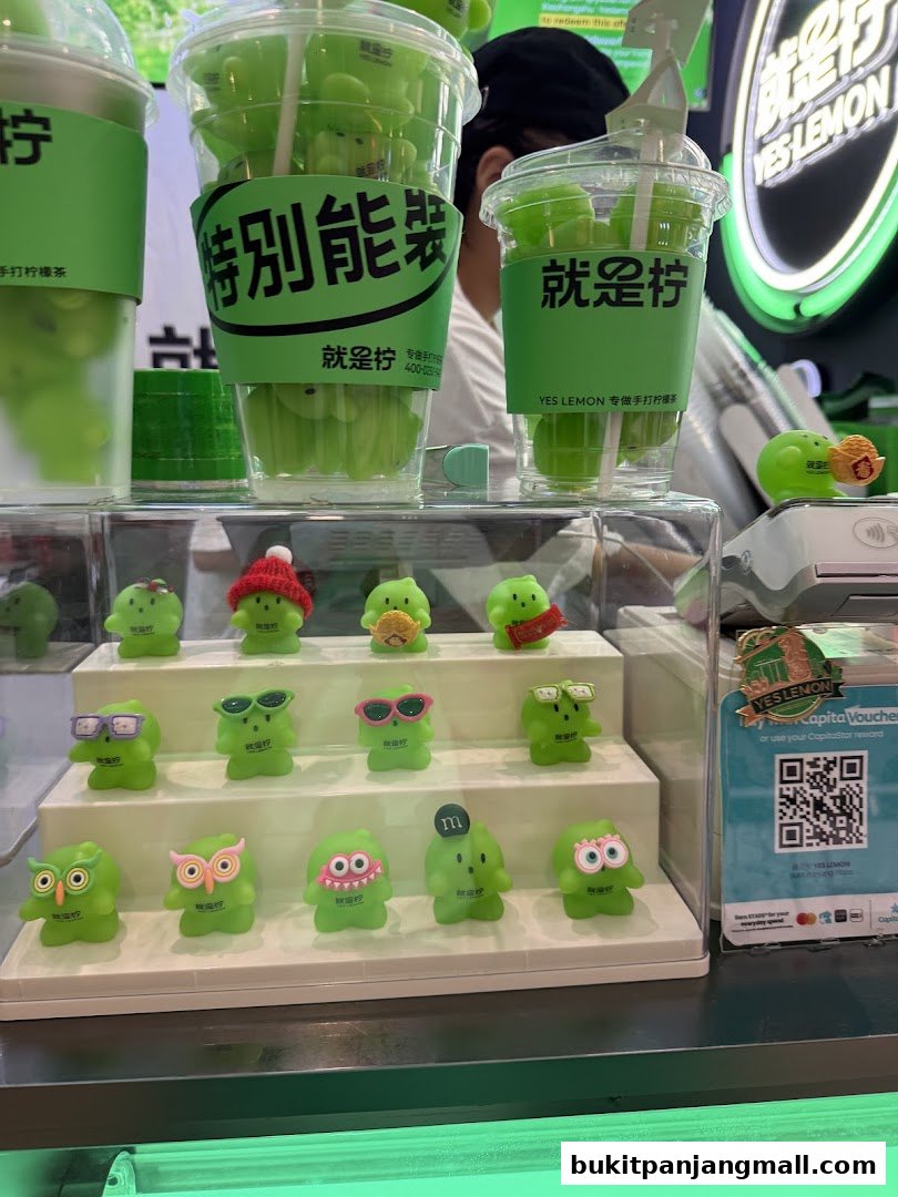 A display of green, cartoon-like figures and drinks from the shop YES LEMON.