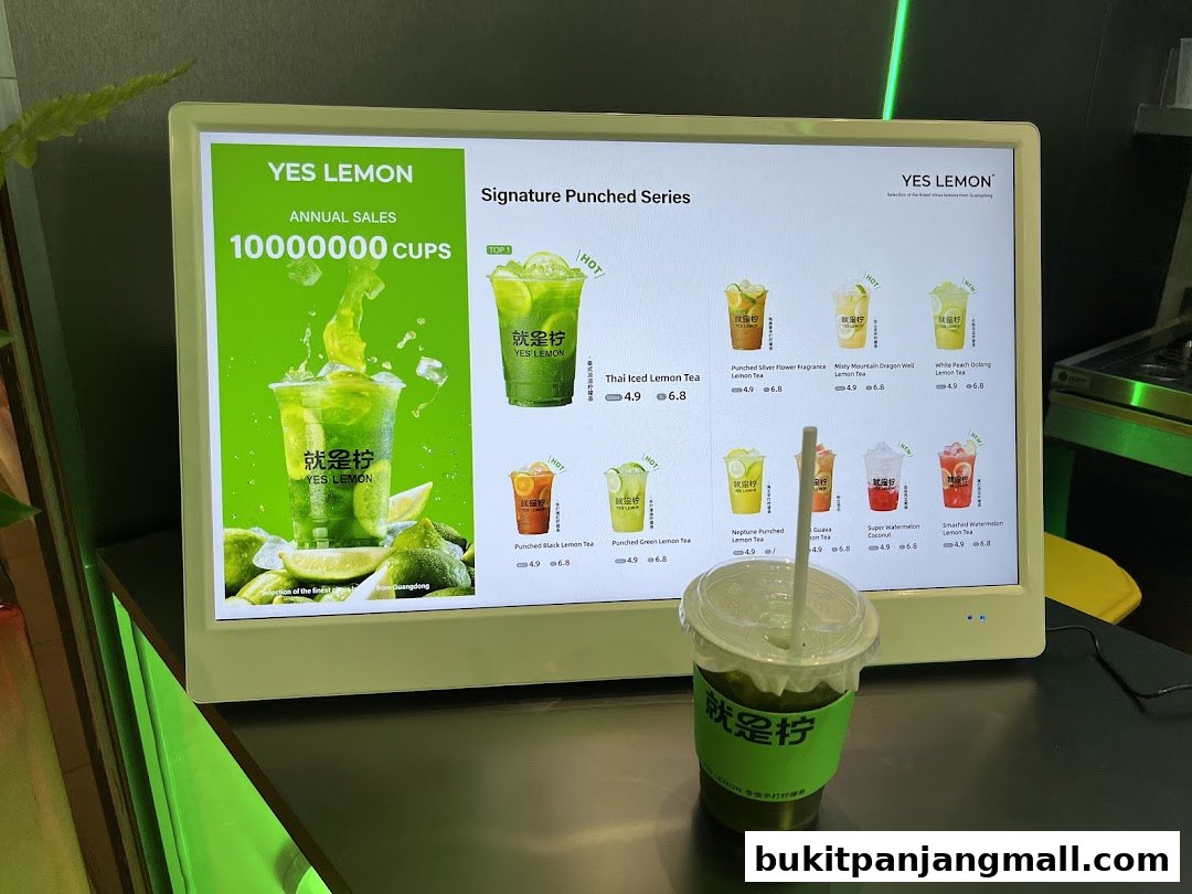 A digital menu board displaying various lemon tea drinks with images and prices.