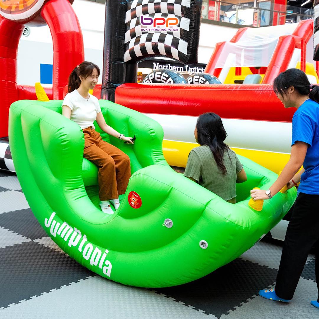 Kids enjoying a large inflatable slide at Jumptopia Lite